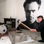 Keef Winter 'Tax Return' performance, artist uses sledgehammer to break down a filing cabinet