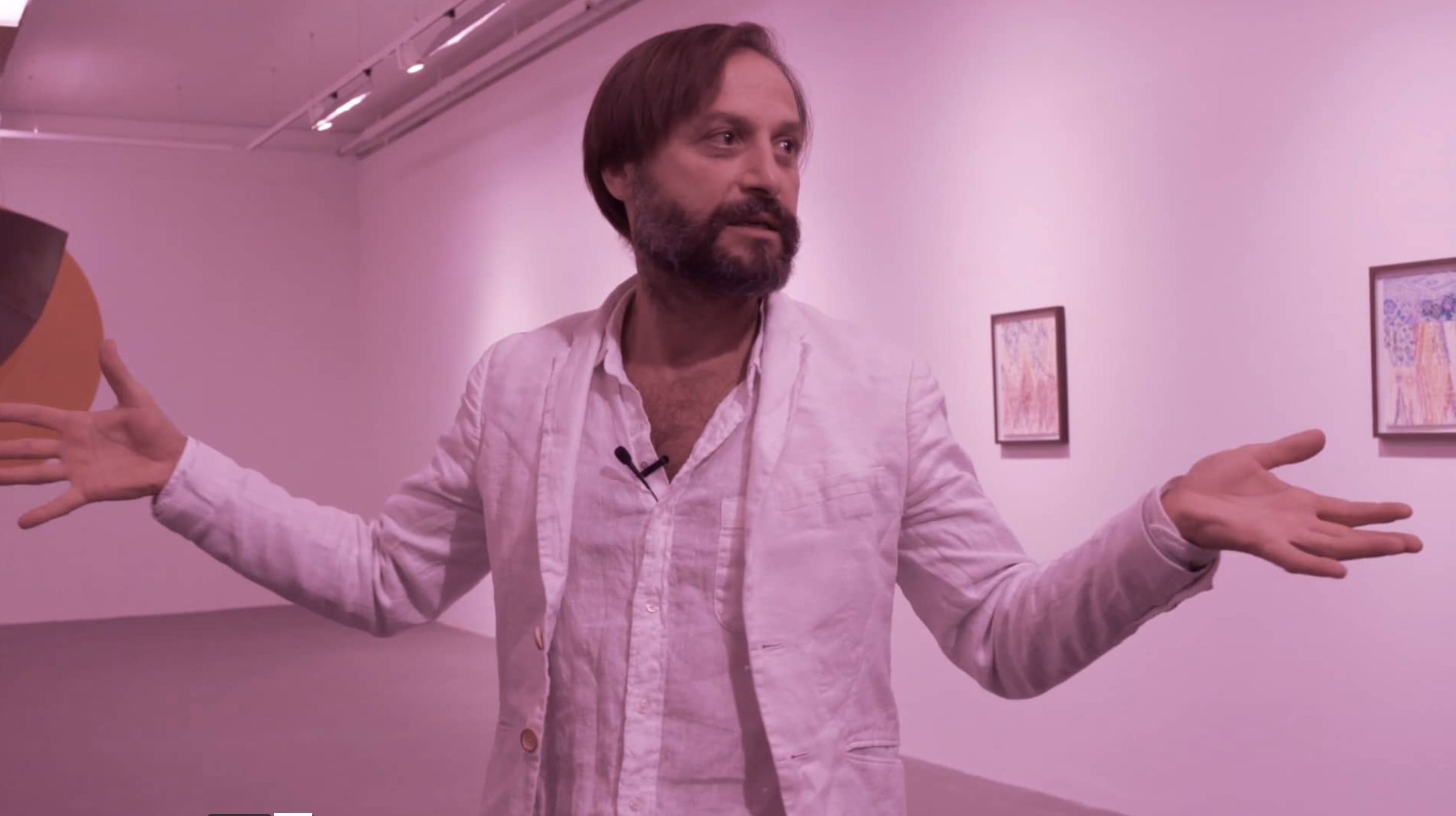 Artist Alex Cecchetti stands looking towards the audience of his artist's talk for exhibition at Void Gallery titled At the Gates of the Music Palace in Void 2018
