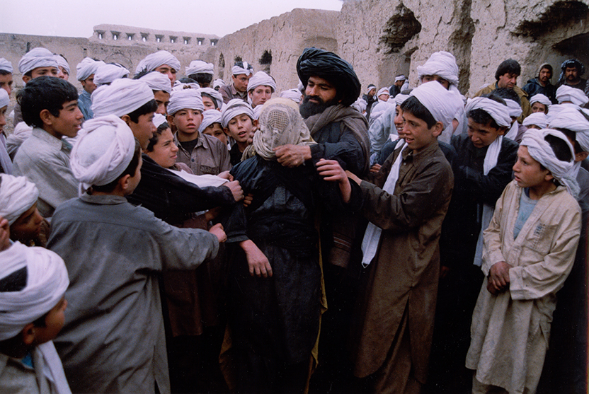 group of boys and men in white headdresses.