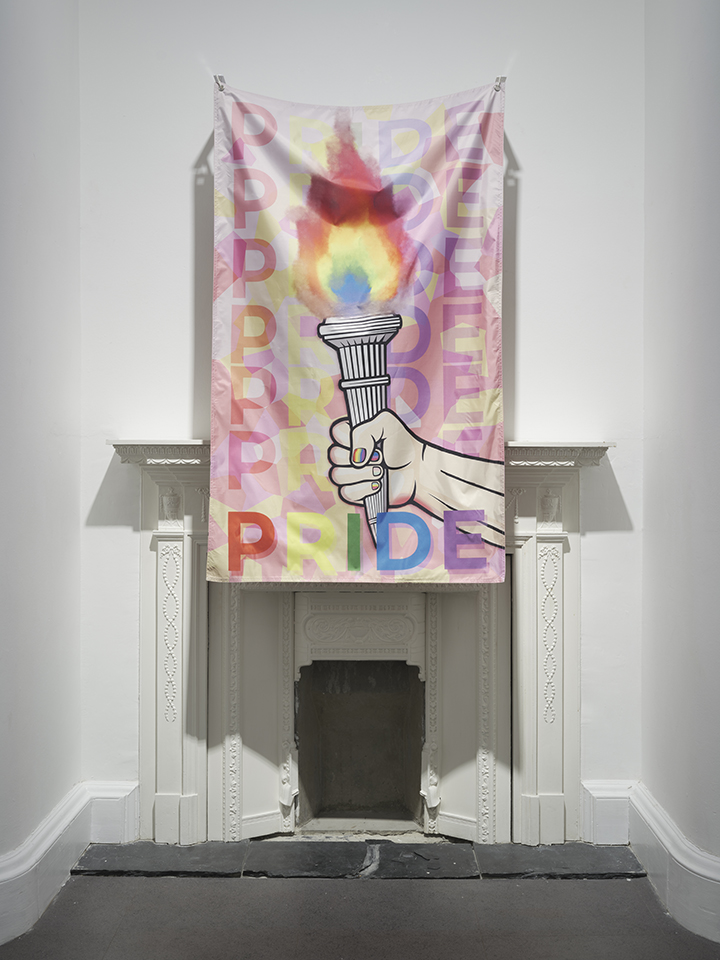 a poster with pride written hanging above a white fireplace in a white wall
