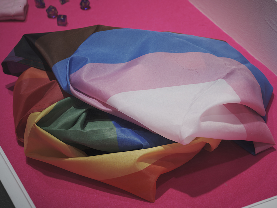 a rainbow flag on a fuchsia table