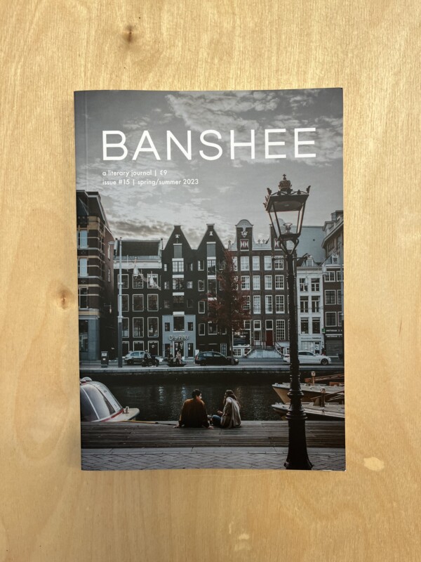 The cover of Banshee Issue 15, a literary journal showing an Amsterdam streetscape.